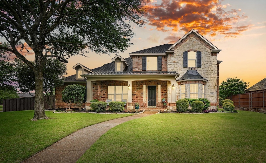 2099 Remington Ln, Frisco, TX 75033 - view of front of house featuring a standing seam roof, brick siding, and stone siding
