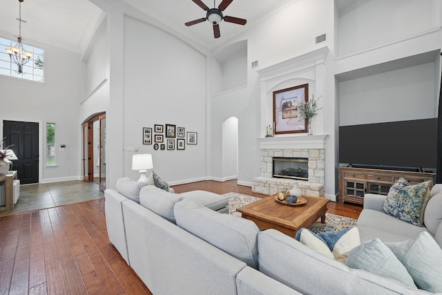 2099 Remington Ln, Frisco, TX 75033 - living area with arched walkways, a towering ceiling, ceiling fan, wood-type flooring, and a chandelier