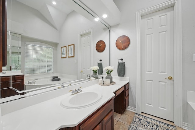 2099 Remington Ln, Frisco, TX 75033 - full bathroom featuring a bath, vanity, tile patterned flooring, and vaulted ceiling