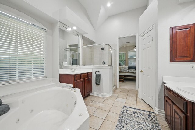 2099 Remington Ln, Frisco, TX 75033 - bathroom with a stall shower, two vanities, lofted ceiling, a whirlpool tub, and tile patterned floors