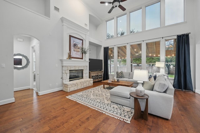2099 Remington Ln, Frisco, TX 75033 - living area with a high ceiling, ceiling fan, plenty of natural light, baseboards, and arched walkways