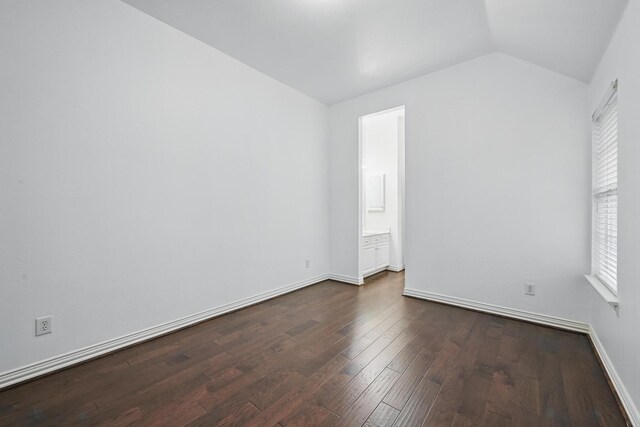 2099 Remington Ln, Frisco, TX 75033 - empty room with vaulted ceiling, dark wood-type flooring, and baseboards