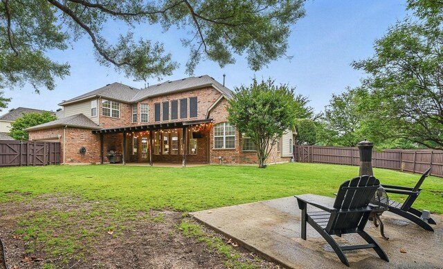 2099 Remington Ln, Frisco, TX 75033 - back of house with a patio area, brick siding, and a gate