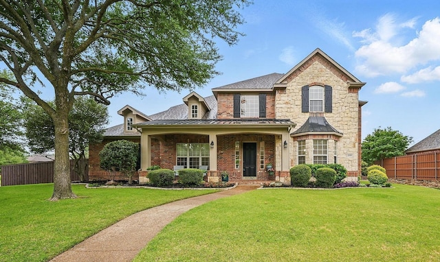 2099 Remington Ln, Frisco, TX 75033 - traditional home featuring a standing seam roof, brick siding, covered porch, and metal roof