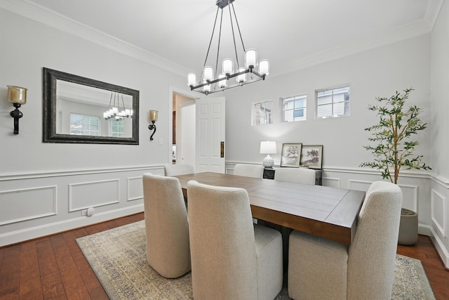 2099 Remington Ln, Frisco, TX 75033 - dining room with a chandelier, ornamental molding, dark wood-type flooring, a wainscoted wall, and a decorative wall