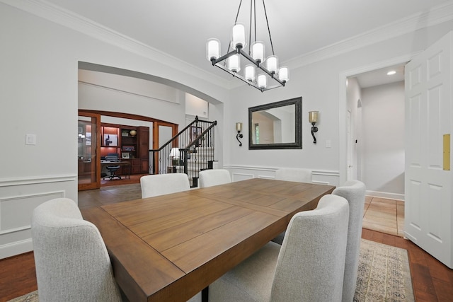 2099 Remington Ln, Frisco, TX 75033 - dining space with arched walkways, ornamental molding, a chandelier, wood finished floors, and recessed lighting