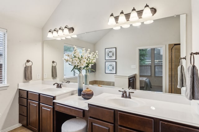 bathroom featuring lofted ceiling, plenty of natural light, double vanity, and an enclosed shower