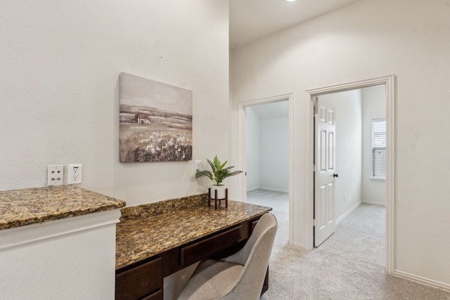 home office with light carpet and baseboards