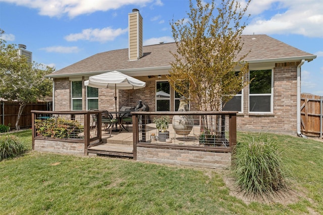 1744 Wildflower Ln, Wylie, TX 75098 - rear view of property featuring a shingled roof, brick siding, a chimney, and a deck