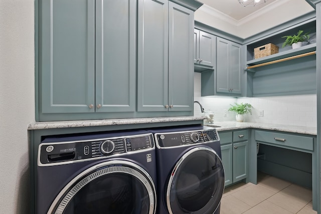 304 Nora Ln, Argyle, TX 76226 - laundry room with separate washer and dryer, cabinet space, ornamental molding, and light tile patterned floors