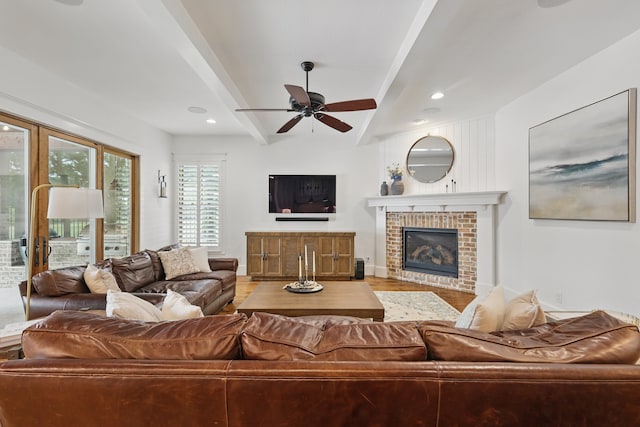 304 Nora Ln, Argyle, TX 76226 - living room with ceiling fan, beamed ceiling, a brick fireplace, wood finished floors, and recessed lighting