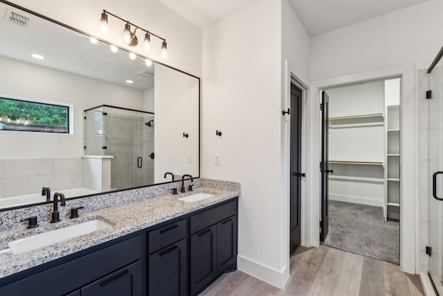 1967 Bayside St, Dallas, TX 75212 - full bathroom with a shower stall, a spacious closet, wood finished floors, double vanity, and a bath