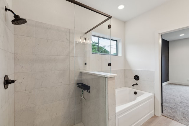 1967 Bayside St, Dallas, TX 75212 - bathroom featuring a tile shower, a garden tub, recessed lighting, and wood finished floors
