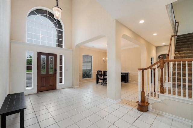 2713 Pasadena Pl, Flower Mound, TX 75022 - foyer with light tile patterned flooring, healthy amount of natural light, stairway, arched walkways, and recessed lighting