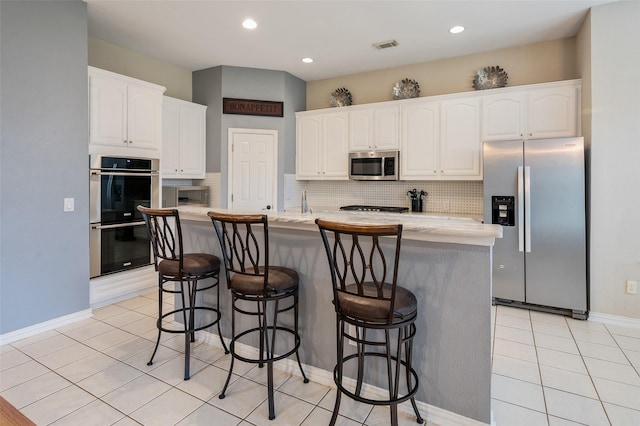 2713 Pasadena Pl, Flower Mound, TX 75022 - kitchen with appliances with stainless steel finishes, white cabinets, backsplash, and recessed lighting