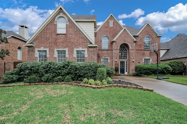2713 Pasadena Pl, Flower Mound, TX 75022 - traditional home featuring a front yard and brick siding