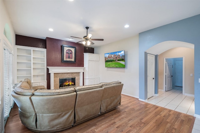 2713 Pasadena Pl, Flower Mound, TX 75022 - living area with arched walkways, ceiling fan, a fireplace, recessed lighting, and light wood-style flooring
