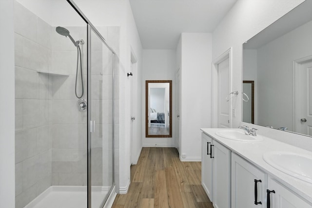 1223 Sequoia Ln, Princeton, TX 75407 - ensuite bathroom with a stall shower, double vanity, and wood finished floors