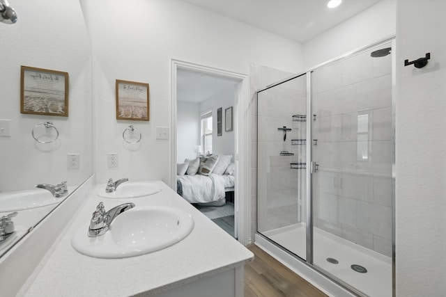1223 Sequoia Ln, Princeton, TX 75407 - full bathroom with double vanity, a stall shower, connected bathroom, and wood finished floors