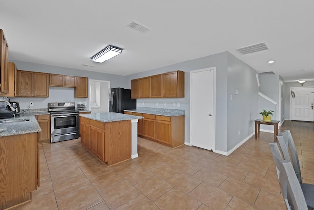3503 Ridge Crossing Dr, Dallas, TX 75227 - kitchen with electric range, black fridge with ice dispenser, a sink, a center island, and brown cabinetry