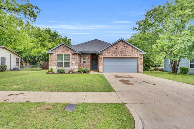 306 N Pendell Ave, Cleburne, TX 76033 - view of front of property featuring a garage, concrete driveway, brick siding, a shingled roof, and central AC