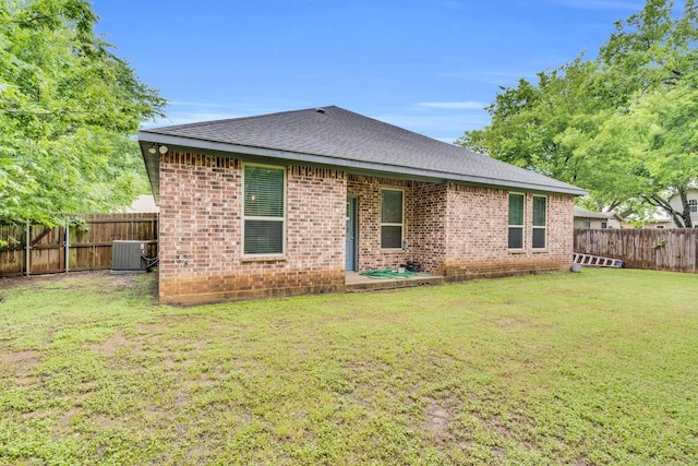 306 N Pendell Ave, Cleburne, TX 76033 - rear view of property featuring central AC, brick siding, and roof with shingles