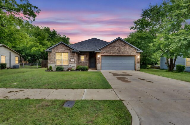 306 N Pendell Ave, Cleburne, TX 76033 - view of front of house with driveway, a garage, brick siding, and roof with shingles