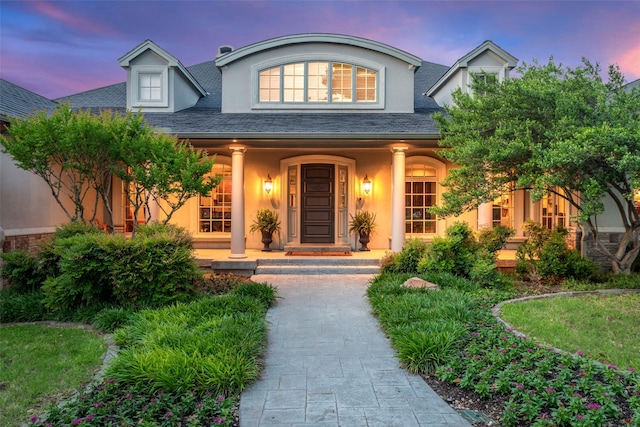 303 Steeplechase Dr, Irving, TX 75062 - view of exterior entry featuring stucco siding, covered porch, and a shingled roof