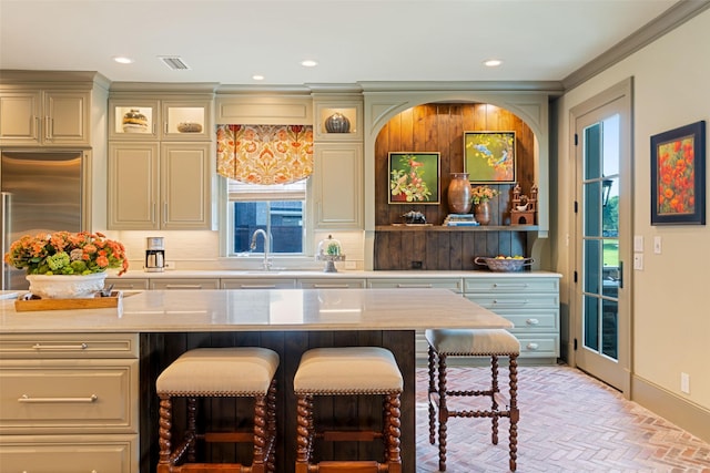 303 Steeplechase Dr, Irving, TX 75062 - bar featuring brick patterned floors, ornamental molding, recessed lighting, built in fridge, and a sink