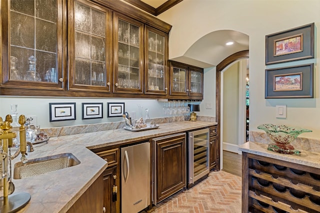 303 Steeplechase Dr, Irving, TX 75062 - indoor wet bar with beverage cooler, brick flooring, refrigerator, and arched walkways