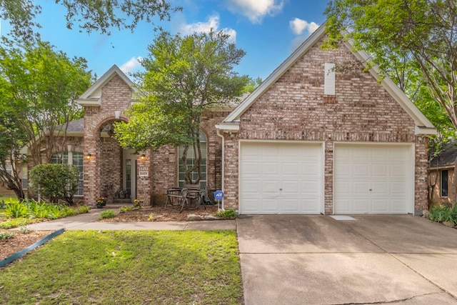 5428 Lake Powell Dr, Fort Worth, TX 76137 - traditional-style house with driveway, an attached garage, brick siding, and a front lawn