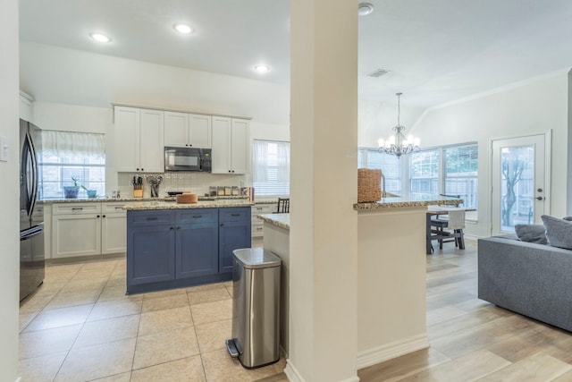 5428 Lake Powell Dr, Fort Worth, TX 76137 - kitchen featuring black appliances, a chandelier, white cabinetry, crown molding, and tasteful backsplash