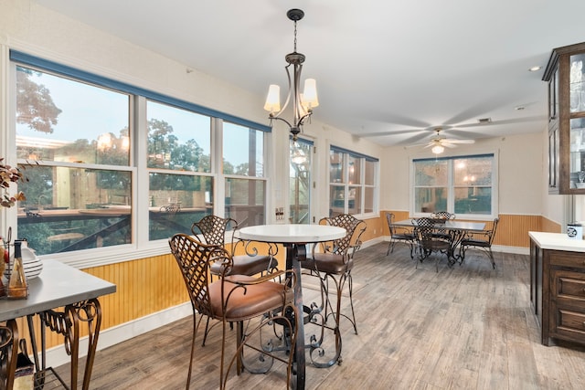 10080 Arvin Hill Rd, Aubrey, TX 76227 - dining room featuring light wood finished floors, a wainscoted wall, healthy amount of natural light, a ceiling fan, and wood walls