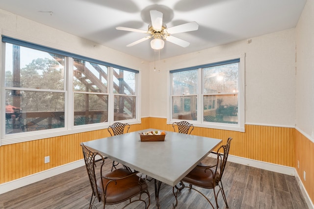 10080 Arvin Hill Rd, Aubrey, TX 76227 - dining area with a wainscoted wall, wood finished floors, wooden walls, a ceiling fan, and baseboards