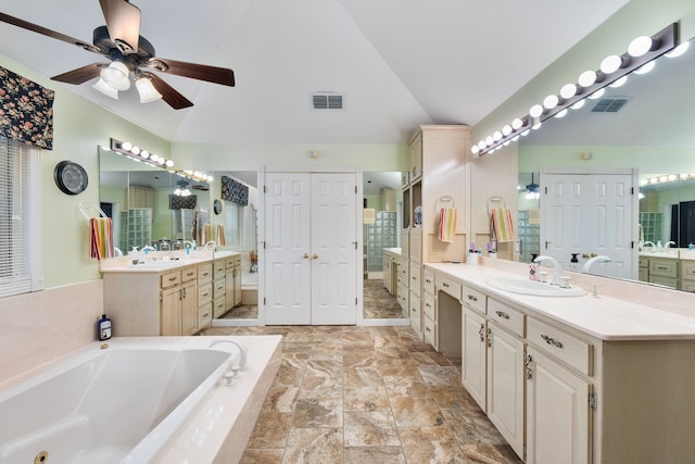 10080 Arvin Hill Rd, Aubrey, TX 76227 - full bathroom with vaulted ceiling, a ceiling fan, a garden tub, two vanities, and a shower stall