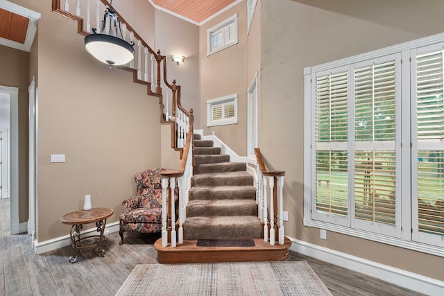 10080 Arvin Hill Rd, Aubrey, TX 76227 - staircase featuring ornamental molding, wood finished floors, baseboards, and a high ceiling