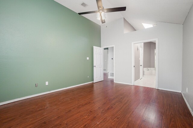 unfurnished living room featuring a ceiling fan, recessed lighting, a towering ceiling, wood finished floors, and baseboards