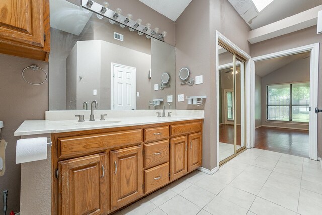 kitchen with appliances with stainless steel finishes, a sink, light countertops, backsplash, and vaulted ceiling