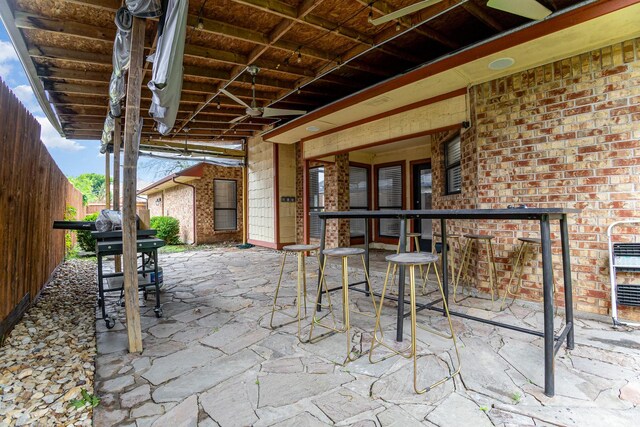 unfurnished room with high vaulted ceiling, a ceiling fan, baseboards, and wood finished floors
