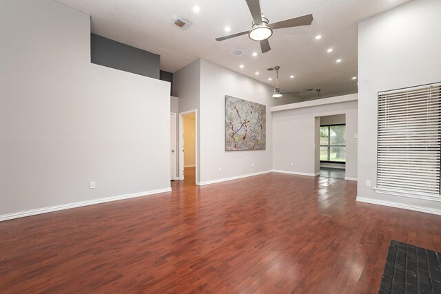doorway with baseboards, dark tile patterned flooring, and a textured wall