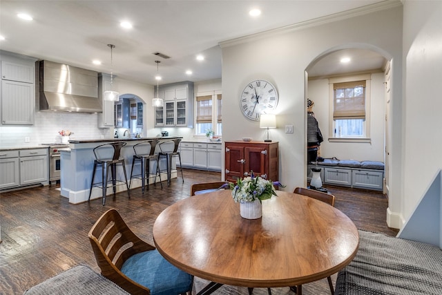 3728 Stanford Ave, University Park, TX 75225 - dining room featuring arched walkways, recessed lighting, dark wood-type flooring, and crown molding