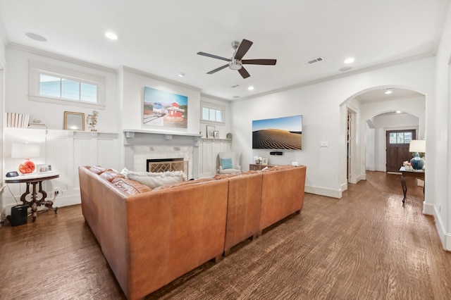 3728 Stanford Ave, University Park, TX 75225 - living room with ceiling fan, arched walkways, a fireplace, ornamental molding, and wood finished floors