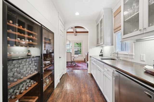 3728 Stanford Ave, University Park, TX 75225 - bar featuring a sink, dishwasher, arched walkways, dark wood finished floors, and beam ceiling