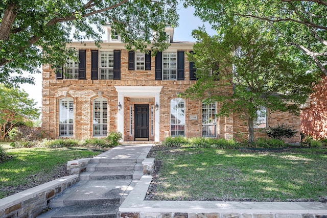 3704 Southport Dr, Plano, TX 75025 - colonial house with brick siding and a front yard