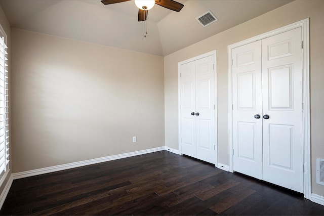 3704 Southport Dr, Plano, TX 75025 - unfurnished bedroom with dark wood finished floors, baseboards, a ceiling fan, multiple closets, and lofted ceiling