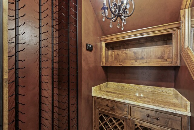 bathroom featuring a chandelier and lofted ceiling