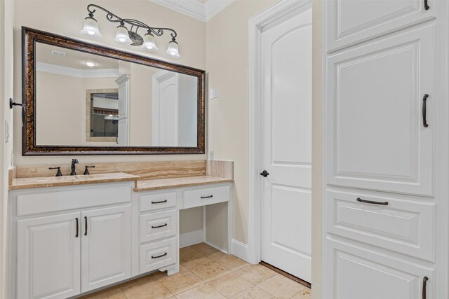 bathroom featuring crown molding, vanity, tile patterned floors, and baseboards