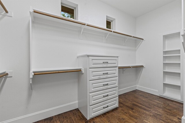 spacious closet with dark wood-style floors