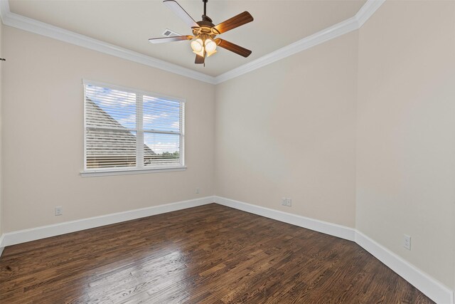 spare room featuring ornamental molding, dark wood finished floors, ceiling fan, and baseboards