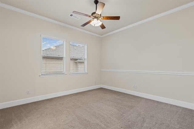 empty room with ornamental molding, carpet, baseboards, and ceiling fan